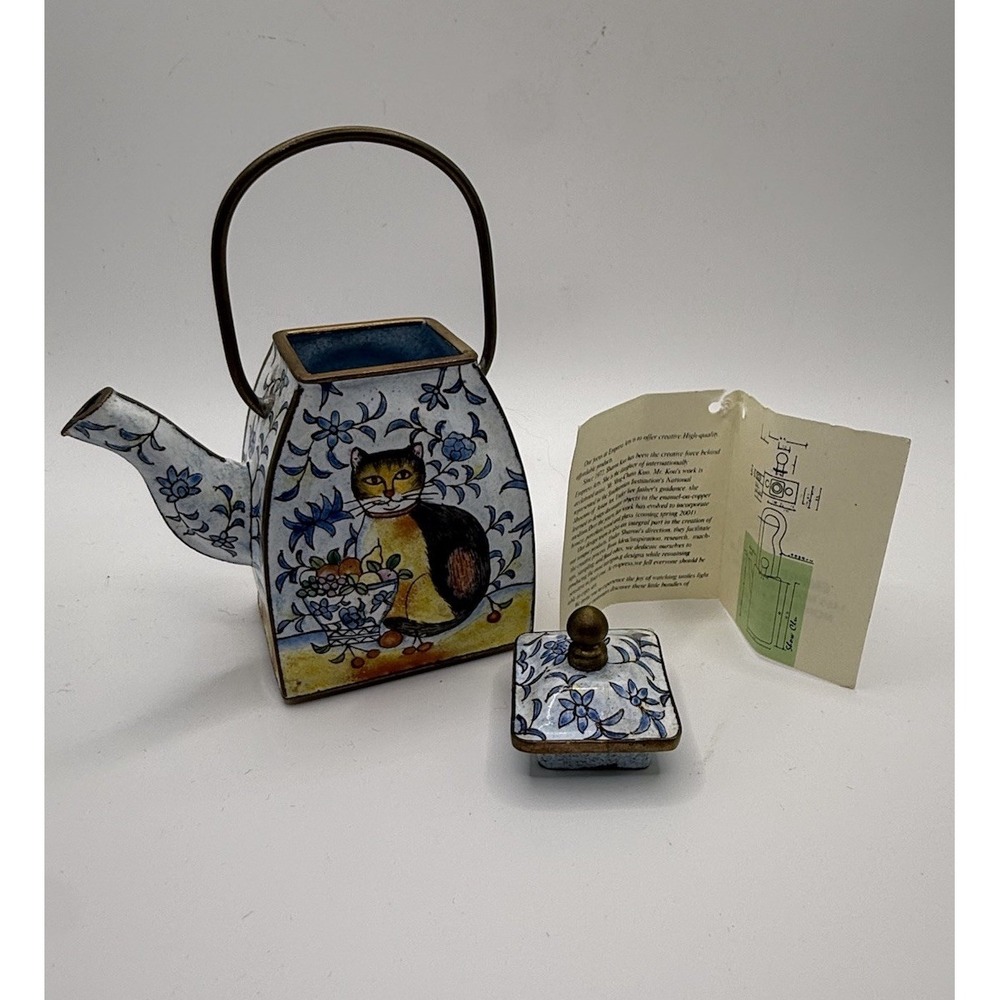 Miniature Square Shaped Enamel Teapot Featuring A Painted Cat Holding A Basket